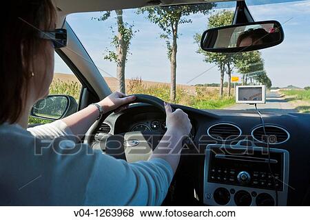 A woman driving her car on a country road in Germany, Europe View Large Photo Image Stock Photo - A woman driving her car on a country road in Germany, Europe. Fotosearch