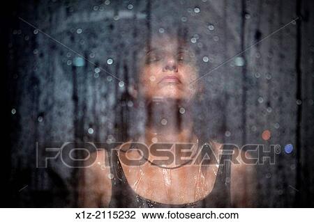 Stock Image - A woman enjoys a spa shower. Barcelona, Spain.. Fotosearch