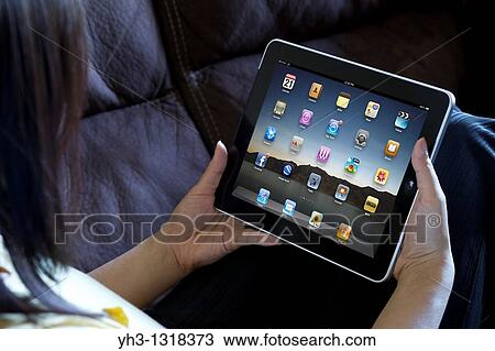 A woman hand holding an ipad showing iPad applications screen View Large Photo Image Stock Image - A woman hand holding an ipad showing iPad applications screen. Fotosearch