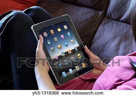A woman hand holding an ipad showing iPad applications screen View Large Photo Image Stock Photo - A woman hand holding an ipad showing iPad applications screen. Fotosearch