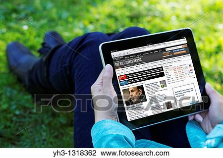 A woman hand holding an iPad while reading The Wall Street Journal online news View Large Photo Image Stock Image - A woman hand holding an iPad while reading The Wall Street Journal online news. Fotosearch