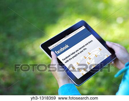 A woman hand holding an iPad while showing Facebook screen View Large Photo Image Stock Photo - A woman hand holding an iPad while showing Facebook screen. Fotosearch