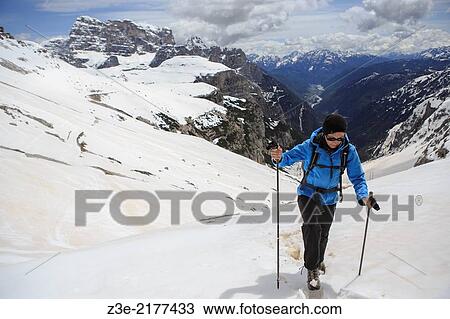 Stock Image - A woman hiking in Drei Zinnen alias Tre Cime area in South Tirol, Italy.. Fotosearch
