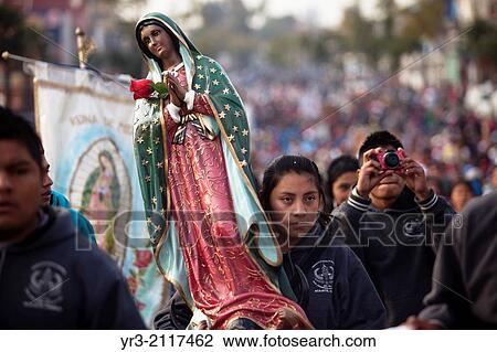 A woman holds a picture of the Virgin of Guadalupe decorated with flowers at the pilgrimage to Our Lady of Guadalupe Basilica in Mexico City, Mexico, December 10, 2013. View Large Photo Image Stock Image - A woman holds a picture of the Virgin of Guadalupe decorated with flowers at the pilgrimage to Our Lady of Guadalupe Basilica in Mexico City, Mexico, December 10, 2013.. Fotosearch