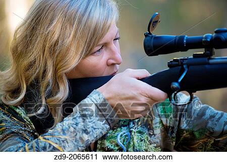 A woman hunter aims her Winchester. View Large Photo Image Stock Image - A woman hunter aims her Winchester.. Fotosearch