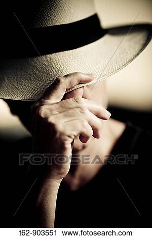 A woman is protected from the sun with his Panama hat View Large Photo Image Stock Image - A woman is protected from the sun with his Panama hat. Fotosearch