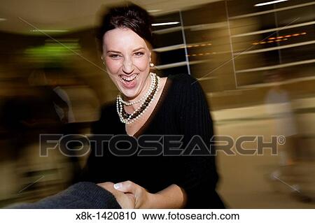 Stock Image - A woman is spun around in circles, shot from POV of man holding her hand NOT MOTION BLUR. Fotosearch
