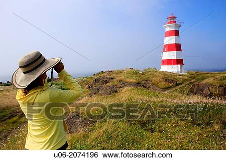 A woman looking through binoculars near the Brier Island Lighthouse at West Point, Brier Island, Nova Scotia, Canada View Large Photo Image Stock Photograph - A woman looking through binoculars near the Brier Island Lighthouse at West Point, Brier Island, Nova Scotia, Canada. Fotosearch
