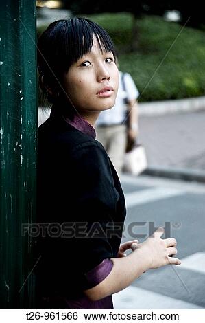 A woman looks at the camera. Shanghai, China View Large Photo Image Stock Photograph - A woman looks at the camera. Shanghai, China. Fotosearch