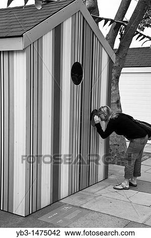 A woman looks into a customised beach hut, The Southbank, London, England View Large Photo Image Stock Image - A woman looks into a customised beach hut, The Southbank, London, England. Fotosearch