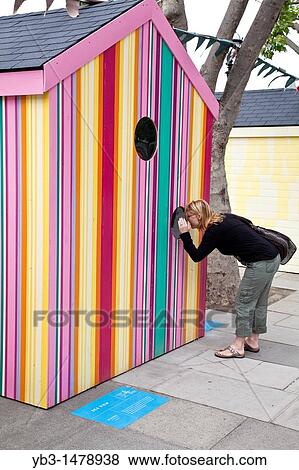 A woman looks through the window of a beach hut, erected for the festival of Britain, The Southbank, London, England View Large Photo Image Stock Photo - A woman looks through the window of a beach hut, erected for the festival of Britain, The Southbank, London, England. Fotosearch