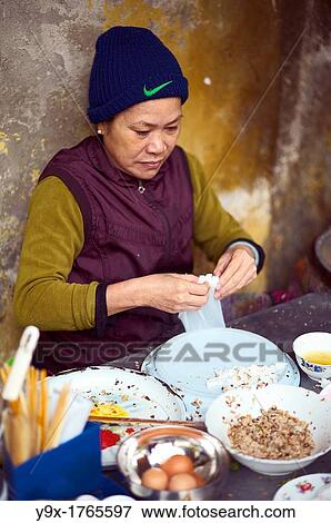 A woman making banh cuon, or rolled stuffed rice noodle, on the streets of Vietnam View Large Photo Image Stock Photo - A woman making banh cuon, or rolled stuffed rice noodle, on the streets of Vietnam. Fotosearch