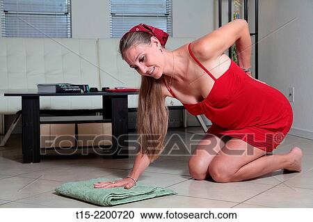 A woman mopping the floor getting hurt. View Large Photo Image Stock Image - A woman mopping the floor getting hurt.. Fotosearch