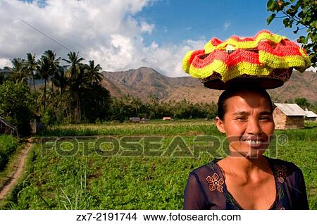 A woman next to some fields near the fishing village of Amed East Bali culture. View Large Photo Image Picture - A woman next to some fields near the fishing village of Amed East Bali culture.. Fotosearch