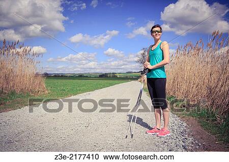 a woman nordic walking through the rural landscape near Coburg, Germany. View Large Photo Image Stock Image - a woman nordic walking through the rural landscape near Coburg, Germany.. Fotosearch