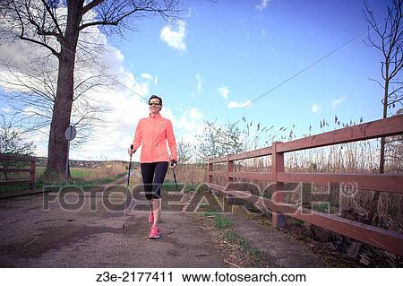 a woman nordic walking through the rural landscape near Coburg, Germany. View Large Photo Image Stock Image - a woman nordic walking through the rural landscape near Coburg, Germany.. Fotosearch