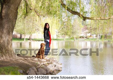 A woman outdoors with her Golden Retriever View Large Photo Image Stock Photo - A woman outdoors with her Golden Retriever. Fotosearch