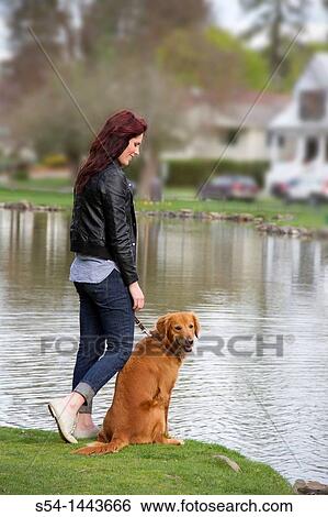 A woman outdoors with her Golden Retriever View Large Photo Image Stock Photograph - A woman outdoors with her Golden Retriever. Fotosearch