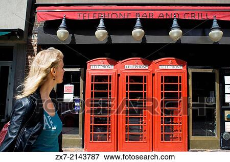A woman passes the Telephone Bar and Grill Restaurant in the East Village View Large Photo Image Stock Photo - A woman passes the Telephone Bar and Grill Restaurant in the East Village. Fotosearch