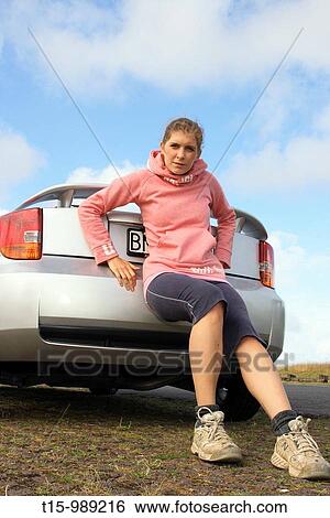 A woman pushing a broken down car View Large Photo Image Stock Photograph - A woman pushing a broken down car. Fotosearch