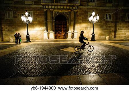 a woman riding a bike in front of the Catalonian Government, Barcelona, Spain. View Large Photo Image Stock Image - a woman riding a bike in front of the Catalonian Government, Barcelona, Spain.. Fotosearch