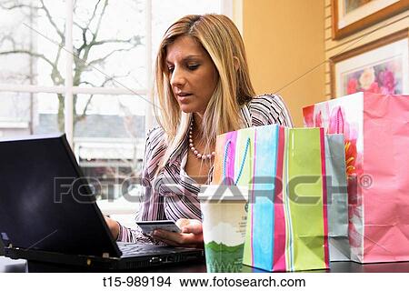 Picture - A woman shopping online. Fotosearch
