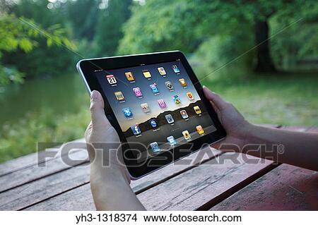 A woman showing iPad applications screen View Large Photo Image Picture - A woman showing iPad applications screen. Fotosearch