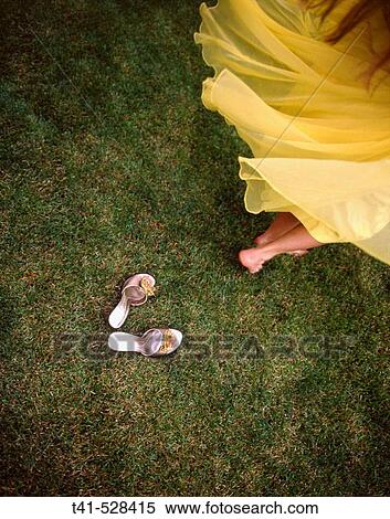 A woman spinning in a vintage yellow dress with her mother's vintage shoes left behind. View Large Photo Image Stock Photography - A woman spinning in a vintage yellow dress with her mother's vintage shoes left behind.. Fotosearch