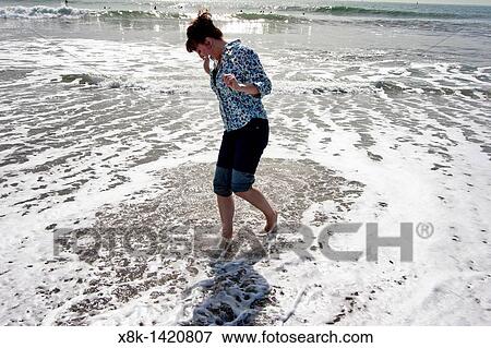 A woman splashes about in the Pacfic Ocean at Rodeo Cove near San Francsico, CA View Large Photo Image Stock Photo - A woman splashes about in the Pacfic Ocean at Rodeo Cove near San Francsico, CA. Fotosearch