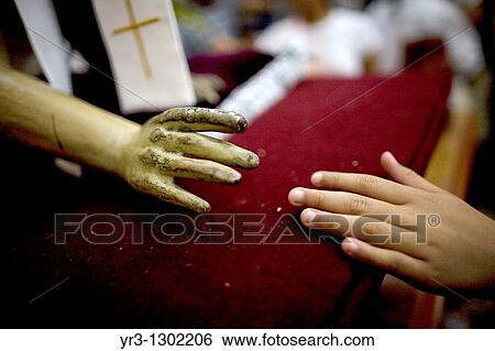 A woman touches the hand of a statue of Jesus Christ during holy week celebrations in Oaxaca, Mexico, April 10, 2009 View Large Photo Image Stock Photograph - A woman touches the hand of a statue of Jesus Christ during holy week celebrations in Oaxaca, Mexico, April 10, 2009. Fotosearch
