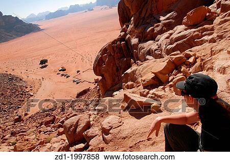 A woman tourist over looking at the wonderful landscape view of Wadi Rum. View Large Photo Image Stock Photo - A woman tourist over looking at the wonderful landscape view of Wadi Rum.. Fotosearch
