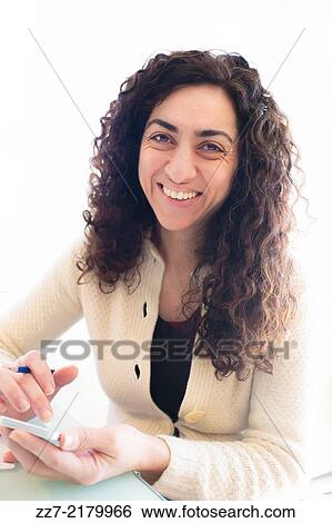 A woman uses a smartphone. View Large Photo Image Stock Photograph - A woman uses a smartphone.. Fotosearch