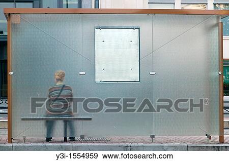A woman waits at a bus stop in Brussels, Belgium View Large Photo Image Stock Photo - A woman waits at a bus stop in Brussels, Belgium. Fotosearch