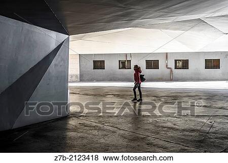 A woman walking with a red coat in a street of Madrid city, Spain. View Large Photo Image Stock Photo - A woman walking with a red coat in a street of Madrid city, Spain.. Fotosearch