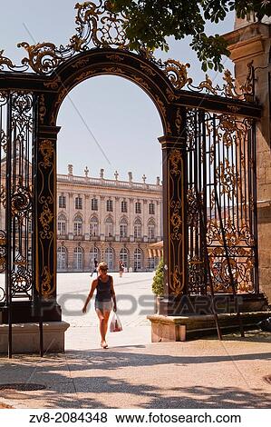 A woman walks out of a gate in Place Stanislas in the french city of Nancy. View Large Photo Image Stock Photo - A woman walks out of a gate in Place Stanislas in the french city of Nancy.. Fotosearch