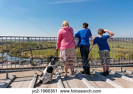 A woman with her two boys admire the view from the top of the church tower in Beccles, Suffolk, England, Britain, Uk. View Large Photo Image Stock Image - A woman with her two boys admire the view from the top of the church tower in Beccles, Suffolk, England, Britain, Uk.. Fotosearch