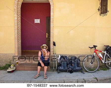A women with a beer and cigarette outside of a bar along the Camino de Santiago, in the village of Ledigos View Large Photo Image Stock Photo - A women with a beer and cigarette outside of a bar along the Camino de Santiago, in the village of Ledigos. Fotosearch