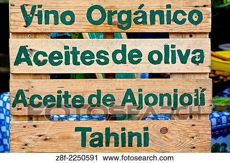 A wooden sign with the words: organic wine, olive oil, sesame oil and tahini in spanish. View Large Photo Image Stock Image - A wooden sign with the words: organic wine, olive oil, sesame oil and tahini in spanish.. Fotosearch