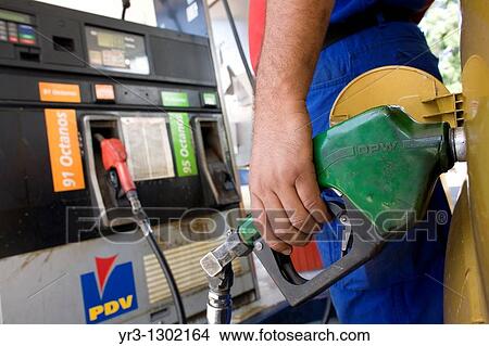 Picture - A workers pumps gas at a gas station in Caracas, Venezuela, July 23, 2008. Fotosearch