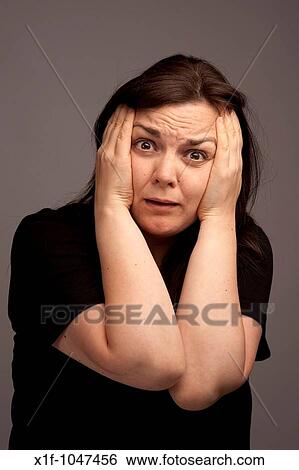 a worried panicked anxious concerned frightened horrifed terrified woman with her head in her hands View Large Photo Image Stock Photograph - a worried panicked anxious concerned frightened horrifed terrified woman with her head in her hands. Fotosearch