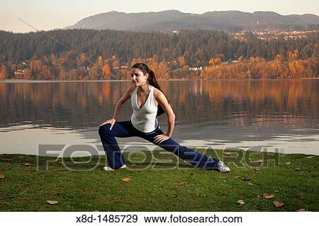 A young athletic woman stretching her legs, Inlet Park, Port Moody, British Columbia, Canada View Large Photo Image Stock Photo - A young athletic woman stretching her legs, Inlet Park, Port Moody, British Columbia, Canada. Fotosearch