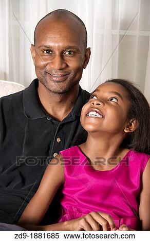 A young black girl enjoys the company of her handsome father View Large Photo Image Stock Photography - A young black girl enjoys the company of her handsome father. Fotosearch