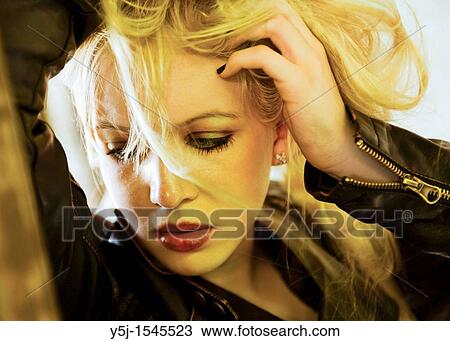 A young blond Caucasian female holding her hair up View Large Photo Image Stock Image - A young blond Caucasian female holding her hair up. Fotosearch