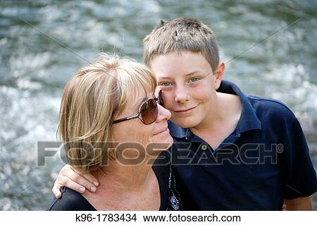 a young boy and an adult woman hugging View Large Photo Image Picture - a young boy and an adult woman hugging. Fotosearch