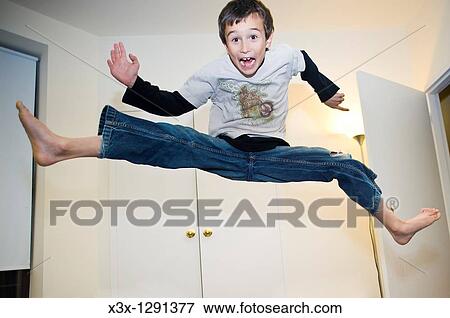 A young boy doing a funny jump View Large Photo Image Stock Photo - A young boy doing a funny jump. Fotosearch