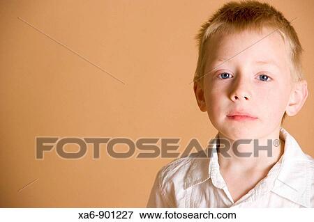 A young boy, looking slightly anxious View Large Photo Image Stock Photo - A young boy, looking slightly anxious. Fotosearch