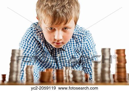 A young boy of 10 counts his money and stacks it up. View Large Photo Image Stock Photo - A young boy of 10 counts his money and stacks it up.. Fotosearch