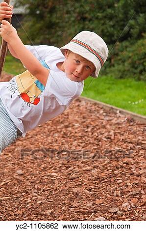 Stock Image - A young boy on a zip slide at Gressenhall museum of rural life in North Norfolk Uk. Fotosearch