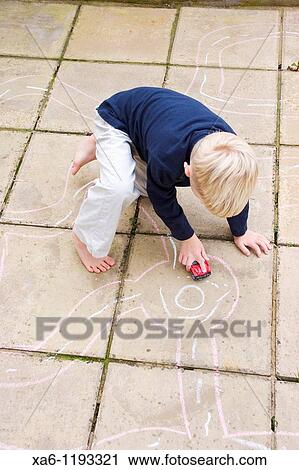 A young boy plays with his toy car on roads drawn on patio slabs with chalk View Large Photo Image Stock Image - A young boy plays with his toy car on roads drawn on patio slabs with chalk. Fotosearch