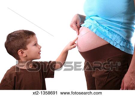 A young boy touches his mothers pregnant stomache, isolated on white background View Large Photo Image Stock Image - A young boy touches his mothers pregnant stomache, isolated on white background. Fotosearch